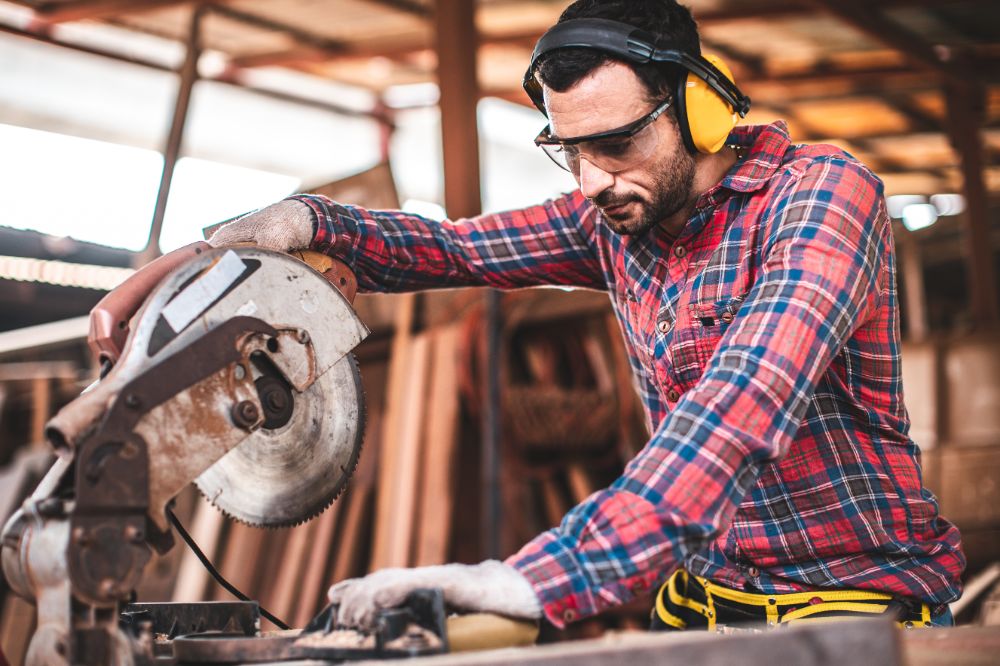 Man working at his carpentry business financially protected from accidents with insurance