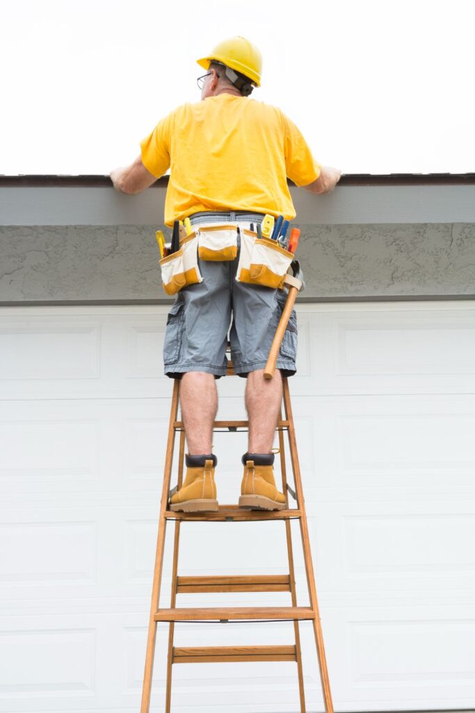 Contractor standing on ladder financially protected by insurance if he were to fall