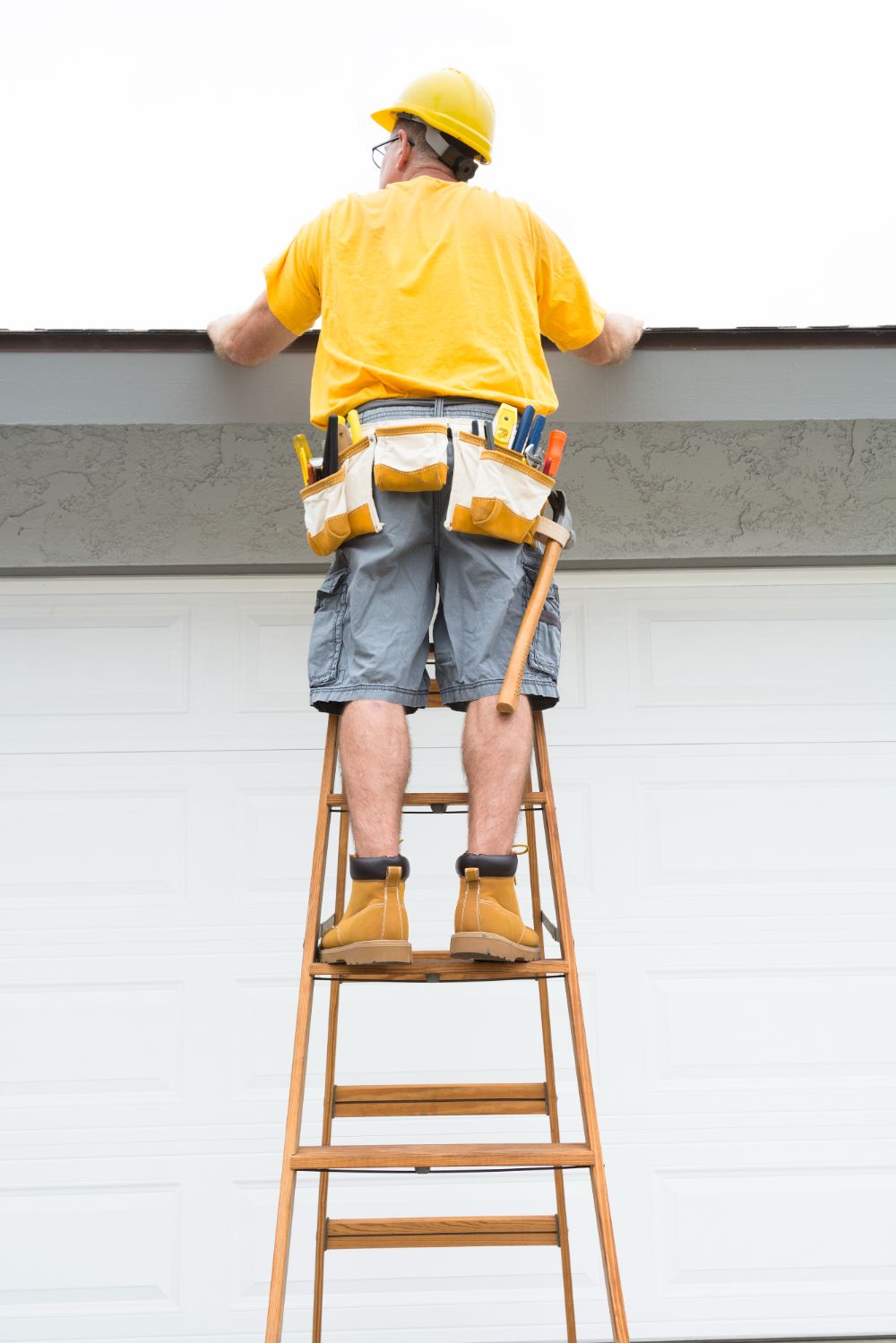 Contractor standing on ladder financially protected by insurance if he were to fall