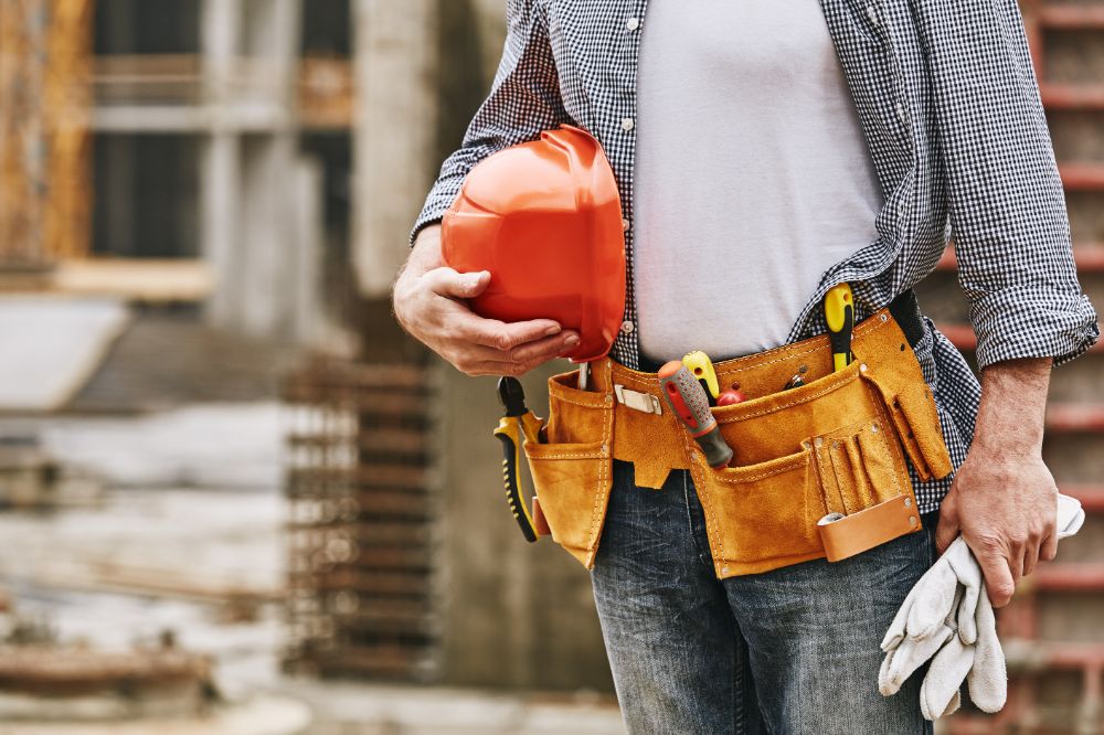 Male builder with tools that has an insurance policy