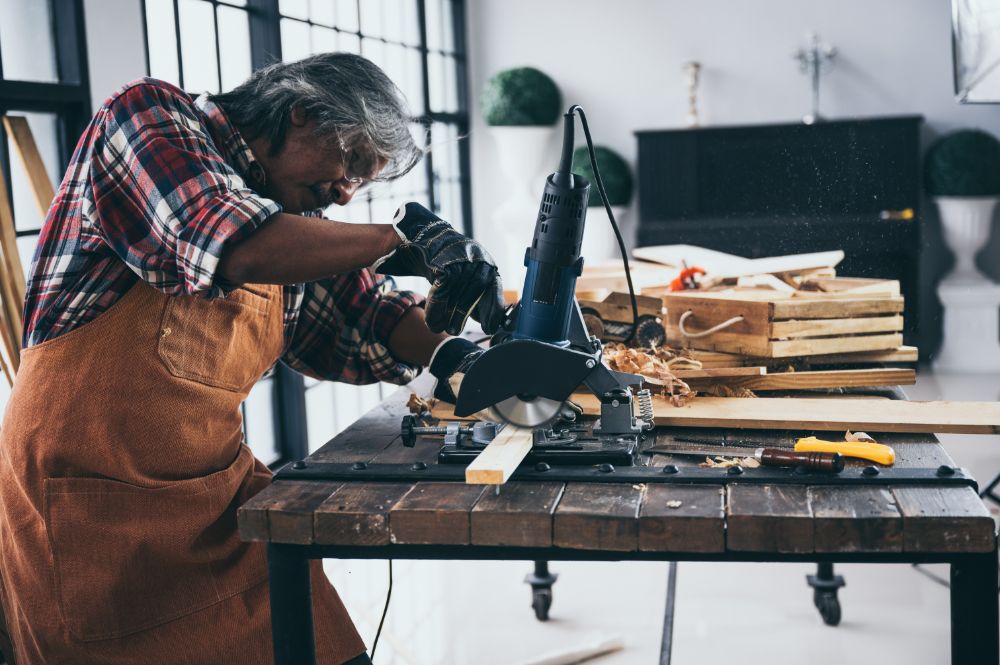 Male carpenter woodworking with buzzsaw