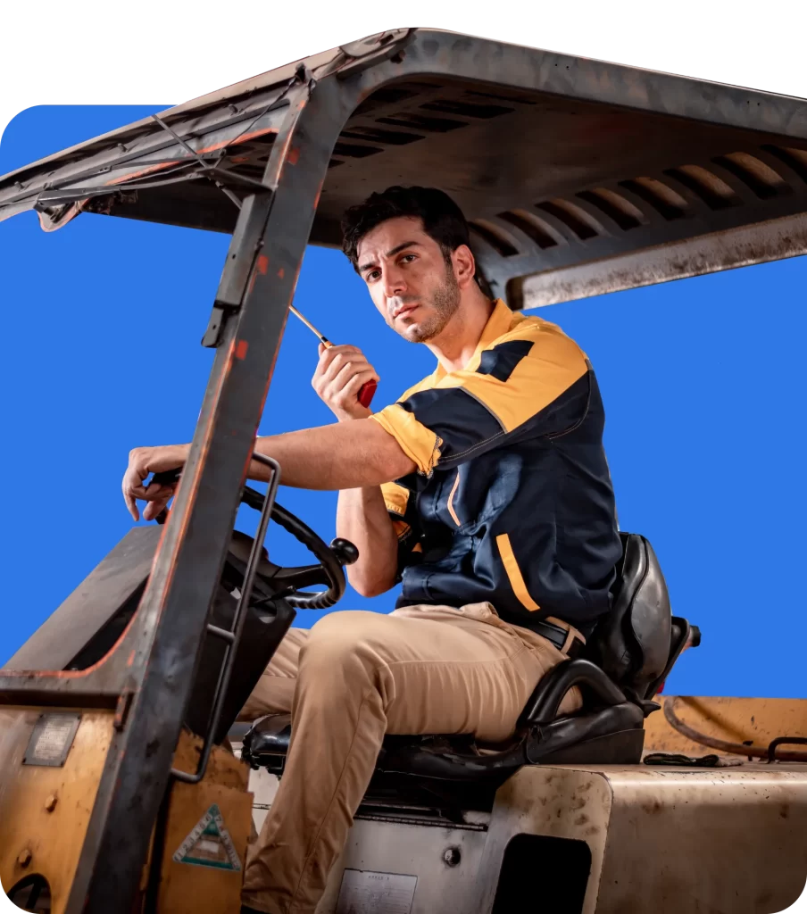 A person in a uniform sits in the driver's seat of a forklift, holding a handheld radio to his mouth, ensuring everything runs smoothly with the help of Plant and Equipment Insurance.