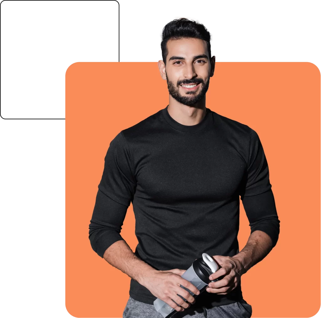 A bearded man in a black long-sleeve shirt holding a water bottle stands against an orange background, smiling at the camera, exuding confidence akin to someone well-versed in Professional Indemnity Insurance.