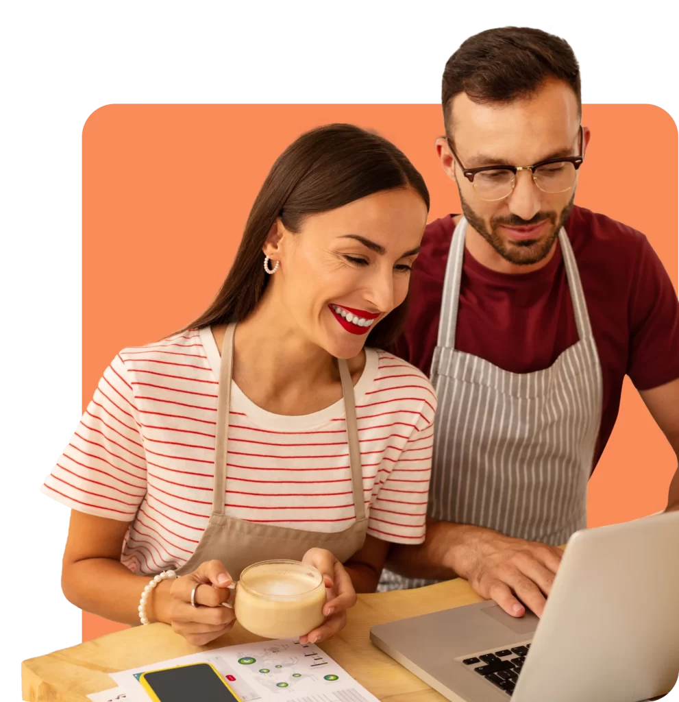 Two people in aprons look at a laptop screen. One holds a coffee cup and a piece of paper detailing Public Liability Insurance is on the table. The background is orange.